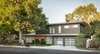 Modern home with Exterior, House Building Type, Metal Roof Material, and Wood Siding Material. Area of new addition. Floor to ceiling glass area between the addition and the original structure where stairwell is located. New addition was kept to the same low ceiling heights and flat roofing to match original. Horizontal cedar siding and aluminum windows to match original. Photo 10 of Richthofen Residence