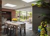 Modern home with Outdoor, Back Yard, Concrete Patio, Porch, Deck, Horizontal Fences, Wall, Shrubs, and Trees. Covered outdoor dining area outside of kitchen door. Old storage shed was turned into an outdoor bbq and kitchen. Patio trellis structure added on for expanded indoor/outdoor living. Photo 13 of Richthofen Residence