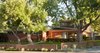 Modern home with Exterior, House Building Type, Metal Roof Material, and Brick Siding Material. Exterior of home with original 1950's ranch in the foreground and addition setback beyond. Photo 9 of Richthofen Residence