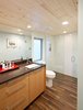 Modern home with Bath Room, Engineered Quartz Counter, Porcelain Tile Floor, Undermount Sink, Ceiling Lighting, Ceramic Tile Wall, Two Piece Toilet, and Open Shower. Bathroom in master suite addition. Custom white oak vanity by AvenueTwo:Design. Zero threshold shower. Photo 2 of Jersey Way Residence