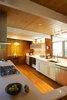 Modern home with Kitchen, Engineered Quartz Counter, White Cabinet, Metal Backsplashe, Ceiling Lighting, Medium Hardwood Floor, Pendant Lighting, Cooktops, Dishwasher, Microwave, and Undermount Sink. Original kitchen was opened up and expanded into small breakfast nook area. Photo 4 of Jersey Way Residence