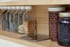 Modern home with Kitchen, Engineered Quartz Counter, and Wood Cabinet. Detail shot of custom spice rack by AvenueTwo:Design with pop up outlets. Photo 7 of Pletcher Kitchen