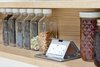 Modern home with Kitchen, Engineered Quartz Counter, and Wood Cabinet. Detail shot of custom spice rack by AvenueTwo:Design with pop up outlets. Photo 8 of Pletcher Kitchen