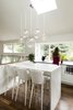 Modern home with Kitchen, Engineered Quartz Counter, White Cabinet, Pendant Lighting, Microwave, and Dark Hardwood Floor. Custom eat-in kitchen table. Solid Caesarstone waterfall fabricated by YK Stone. Photo 6 of Maplewood Residence