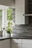 Modern home with Kitchen, Engineered Quartz Counter, White Cabinet, and Stone Tile Backsplashe. Detail of natural stone backsplash by Decorative Materials Inc. High gloss white cabinets by Vogo. Photo 7 of Maplewood Residence