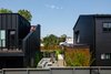 Modern home with Exterior, Metal Roof Material, House Building Type, Metal Siding Material, Gable RoofLine, and Flat RoofLine. View of back patio on main house and adjacent apartment with hottub deck above. Photo 8 of Lawrence Street Residence