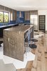 Modern home with Kitchen, Ceiling Lighting, Engineered Quartz Counter, Medium Hardwood Floor, Range, Glass Tile Backsplashe, Wood Cabinet, Granite Counter, and Undermount Sink. Meteor Shower granite waterfall countertop. Photo 12 of Hilltop Residence