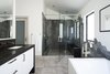 Modern home with Bath Room, Porcelain Tile Wall, Porcelain Tile Floor, Freestanding Tub, Undermount Sink, Engineered Quartz Counter, Full Shower, Enclosed Shower, and Recessed Lighting. Master bathroom suite. Gloss white vanity with dark quartz waterfall countertop. Hexagon tile drops down wall from shower enclosure to tub surround. Photo 10 of Hilltop Residence