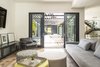 Modern home with Living Room, Chair, Sofa, Gas Burning Fireplace, Ottomans, and Medium Hardwood Floor. Indoor and outdoor living space. Photo 8 of Hilltop Residence