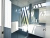 Modern home with Bath Room, Wall Mount Sink, Ceramic Tile Floor, Enclosed Shower, Recessed Lighting, and One Piece Toilet. Master bath Photo 6 of The Sleeve House