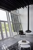 Modern home with Living Room, Chair, Ceiling Lighting, Wood Burning Fireplace, Hanging Fireplace, and Concrete Floor. Living area Photo 9 of The Sleeve House