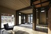 Modern home with Living Room, Medium Hardwood Floor, Wall Lighting, Ceiling Lighting, Bench, and Ottomans. Interior Photo 9 of House in Duhanino