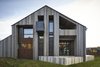 Modern home with Exterior, Metal Siding Material, Wood Siding Material, Shingles Roof Material, Glass Siding Material, and House Building Type. Exterior Photo 5 of House in Duhanino