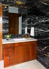 Modern home with Back Yard, Landscape Lighting, Hardscapes, Large Patio, Porch, Deck, Metal Fences, Wall, Ceiling Lighting, Recessed Lighting, Sectional, Coffee Tables, Ottomans, Table, Accent Lighting, Stools, Wood Patio, Porch, Deck, Decking Patio, Porch, Deck, Dresser, Undermount Sink, Pendant Lighting, Two Piece Toilet, and Chair. Black and gold Zebrino marble clad walls, Egyptian travertine floor tiles, Custom walnut vanity with Waterworks Atlas fixture, Pigeon & Poodle accessories, Rejuvanation's Yeon double sconce. Photo 15 of Lake Austin Remodel