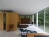 Modern home with Back Yard, Landscape Lighting, Trees, Wood Fences, Wall, Living Room, Bench, Chair, and Travertine Floor. Hold it Home Photo of Hold it Home