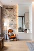 Modern home with Living Room and Gas Burning Fireplace. The natural and rustic tones of these spaces make for a warm and cohesive atmosphere. Photo 3 of The Tribeca Loft
