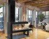 Modern home with Living Room and Gas Burning Fireplace. We sat down with one of the condo owners, Cyndi Collins, to talk about industrial modern design and the new Lucius 140, peninsula fireplace on which her entire design centers.
What first inspired the design for this space?
The overall design of the building was really what inspired us. The exposed brick, the wood beams… it already had such a rustic and unique look. Photo of Buggy Works