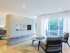 Modern home with Living Room and Gas Burning Fireplace. There was once a wall separating the living and dining rooms, which is now replaced with a unique fireplace feature. Photo of Love It or List It