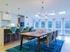 Modern home with Dining Room and Gas Burning Fireplace. Designer, Hillary, created a mid-century modern dining area on the other side of the wall, including a large natural wood table, soft blue chairs and a funky light fixture. Photo 2 of Love It or List It