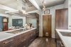 Modern home with Kitchen, Range Hood, Wood Cabinet, Wall Oven, Porcelain Tile Floor, Dishwasher, Refrigerator, Track Lighting, Engineered Quartz Counter, Cooktops, and Undermount Sink. Crystal Cabinetry and Miele appliances Photo 2 of Sunnyvale Eichler Remodel