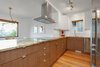 The kitchen features quartzite counter tops and custom cabinets by Semihandmade Photo 8 of The Monolith modern home