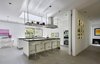 Modern home with Kitchen, Wall Oven, Cooktops, Microwave, Refrigerator, Engineered Quartz Counter, Porcelain Tile Floor, Dishwasher, Ceiling Lighting, Mirror Backsplashe, Range Hood, Undermount Sink, and White Cabinet. Kitchen Photo 4 of The TORO House