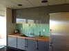 Modern home with Kitchen, Wood Counter, Laminate Cabinet, Medium Hardwood Floor, Recessed Lighting, Refrigerator, Dishwasher, Mirror Backsplashe, Cooktops, Range, and Drop In Sink. Kitchen Photo 5 of Little Box on the Prairie