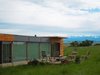 Modern home with Exterior, House Building Type, Metal Roof Material, Wood Siding Material, and Metal Siding Material. Window wall and deck Photo 10 of Little Box on the Prairie