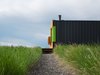 Modern home with Exterior, House Building Type, Metal Roof Material, Wood Siding Material, and Metal Siding Material. Gravel path to house Photo 11 of Little Box on the Prairie