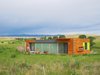 Modern home with Exterior, Metal Roof Material, House Building Type, Wood Siding Material, and Metal Siding Material. Window wall built for the view Photo 16 of Little Box on the Prairie