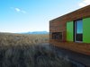 Modern home with Exterior, House Building Type, Metal Roof Material, Wood Siding Material, and Metal Siding Material. Designer and artist Ty Kelly built this 700 square foot home in 2013 as a prefabricated home made from two recycled shipping containers. Firewood storage was kept on the exterior of the home, allowing for space to be saved on the interior; the firewood is stored in a projecting exterior box clad in wood siding that matches that of the rest of the home. Photo 13 of Little Box on the Prairie