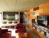 Modern home with Living Room, Chair, Sofa, Coffee Tables, Bookcase, Recessed Lighting, Accent Lighting, Medium Hardwood Floor, Carpet Floor, and Wood Burning Fireplace. Great Room Photo 3 of Little Box on the Prairie