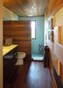 Modern home with Bath Room, Medium Hardwood Floor, Wall Mount Sink, Open Shower, Ceiling Lighting, Wall Lighting, Mosaic Tile Wall, and One Piece Toilet. Bathroom Photo 2 of Little Box on the Prairie