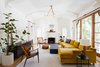 Modern home with Living Room, Wall Lighting, End Tables, Chair, Medium Hardwood Floor, Coffee Tables, Wood Burning Fireplace, Ceiling Lighting, Console Tables, Standard Layout Fireplace, and Sofa. Living room Photo of Dundee Residence