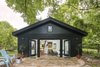 Modern home with Concrete Siding Material, House Building Type, Living Room, Trees, and Back Yard. The old garage is now an eclectic, modern, tiny home. Photo 2 of SvartKub