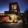 Modern home with House Building Type, Green Roof Material, Exterior, and Metal Siding Material. Front facade at Night Photo of T32 North Park Home