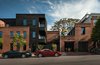 Modern home with Front Yard, Side Yard, Detached Garage Room Type, Wood, Exterior, Swing Door Type, Wood Fences, Wall, Horizontal Fences, Wall, Casement Window Type, Staircase, Glass Railing, and Metal Railing. Tap House, Canton, Baltimore MD Photo of Taphouse