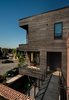 Modern home with Wood Patio, Porch, Deck, Decking Patio, Porch, Deck, Metal Patio, Porch, Deck, Small Patio, Porch, Deck, Exterior, Sliding Door Type, Casement Window Type, Staircase, Glass Railing, and Metal Railing. View of veranda and bridge Photo 7 of Taphouse