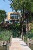 Modern home with Exterior, Glass Siding Material, Metal Roof Material, Stucco Siding Material, Green Roof Material, Flat RoofLine, House Building Type, Wood Siding Material, and Metal Siding Material. View from Boat Dock Photo 7 of Spa Creek House