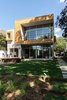 Modern home with Exterior, Glass Siding Material, Green Roof Material, Stucco Siding Material, Metal Siding Material, Flat RoofLine, Metal Roof Material, Wood Siding Material, and House Building Type. View from Southwest Photo 8 of Spa Creek House