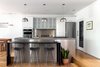Modern home with Ceiling Lighting, Light Hardwood Floor, and Recessed Lighting. Kitchen Elevation Photo 11 of Spa Creek House