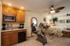 Modern home with Kitchen, Wood Cabinet, Refrigerator, Wood Counter, Dishwasher, Pendant Lighting, Microwave, Engineered Quartz Counter, Carpet Floor, Beverage Center, and Drop In Sink. Mini Kitchen Photo 2 of Waterside Lane 2nd Story Addition over 2 car garage