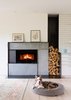 Modern home with Living Room, Gas Burning Fireplace, Standard Layout Fireplace, Light Hardwood Floor, Recessed Lighting, Rug Floor, and Storage. A simple palette of painted brick, white oak, concrete, and raw steel form a visual language that weaves old to new in Zen Light by Barrett Studio Architects. Photo 6 of Zen Light