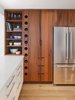 Modern home with Kitchen, Refrigerator, Engineered Quartz Counter, Wood Counter, White Cabinet, Wood Cabinet, and Light Hardwood Floor. Custom spring loaded wine rack made with reclaimed American redwood Photo 5 of Wayne Residence