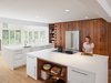 Modern home with Kitchen, Refrigerator, Engineered Quartz Counter, White Cabinet, Wood Cabinet, Light Hardwood Floor, Recessed Lighting, and Undermount Sink. Clean and open kitchen using high gloss white in combination with reclaimed American redwood Photo 2 of Wayne Residence