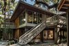 The home seems to sit on stilts, with most living spaces on a second level with cedar batten vaulted ceilings culminating on a clerestory balcony lookout Photo 4 of The Tree House modern home