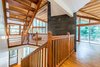 Staying respectful to the original design style, we opened an atrium leading up to the second (main) floor, adding a grander dimension to the space Photo 7 of The Tree House modern home