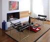 Modern home with Living Room, Coffee Tables, Chair, Gas Burning Fireplace, Medium Hardwood Floor, and Ribbon Fireplace. View of living room in original section of the home Photo 6 of Cerda House