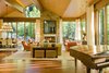 Modern home with Living Room, Chair, Sofa, End Tables, Ceiling Lighting, Table Lighting, Ottomans, Coffee Tables, Accent Lighting, Pendant Lighting, Medium Hardwood Floor, Wood Burning Fireplace, and Standard Layout Fireplace. Living Room Photo 6 of Ute Rock Residence