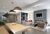 Modern home with Living Room, Chair, Coffee Tables, Sofa, Pendant Lighting, End Tables, Accent Lighting, Ceiling Lighting, Medium Hardwood Floor, and Gas Burning Fireplace. Living Room Photo 2 of Historic Francis House